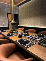 Modern restaurant interior with wooden table and chairs, featuring a sleek design.